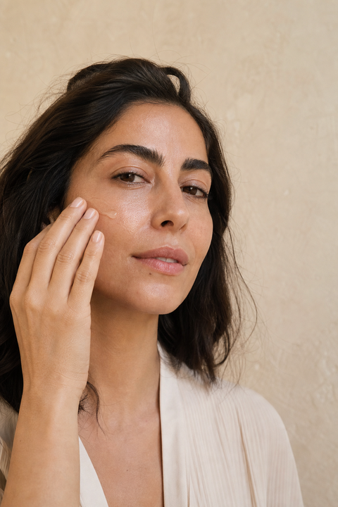 Woman pressing serum into her cheek